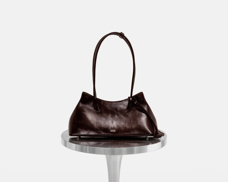 Burgundy KIMIAS Classic Shoulder handbag on a metallic stand against a white background